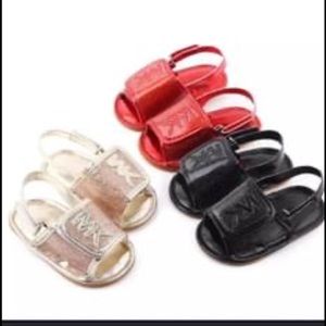 Micheal Kors sandals available in Gold and red.